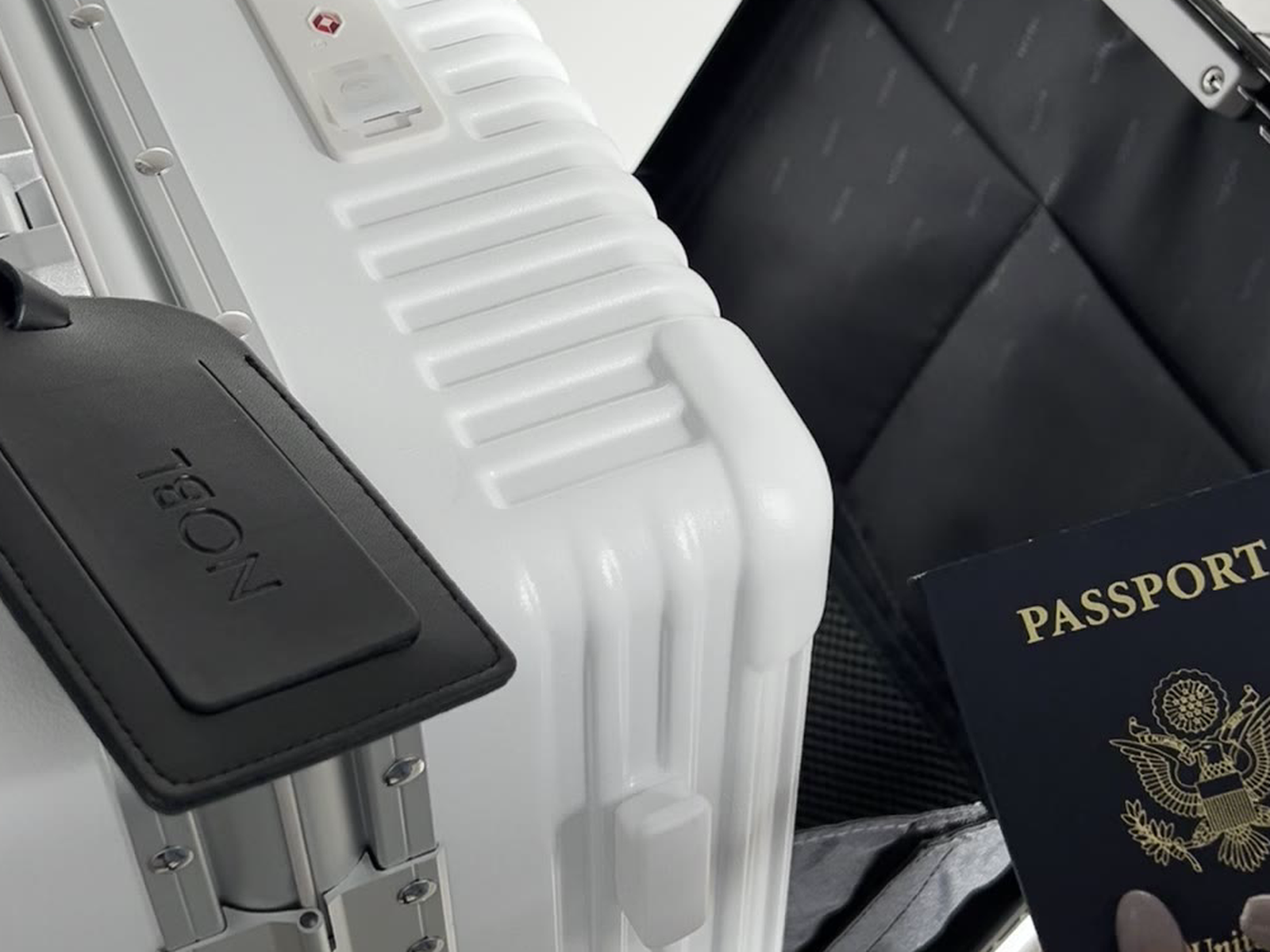 Cup and phone mounted on the NOBL Carry-On handle