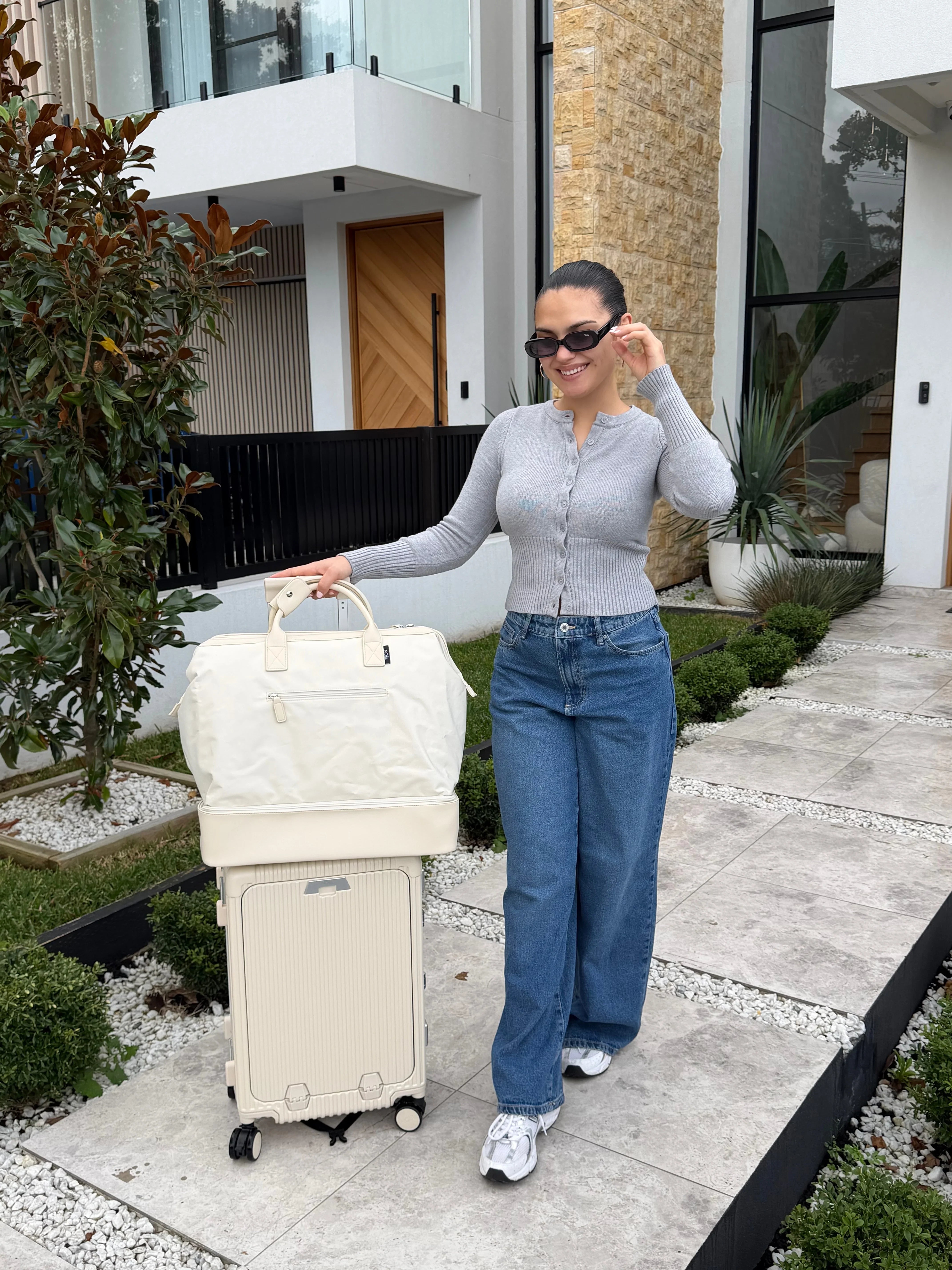 Woman traveling with cream luggage
