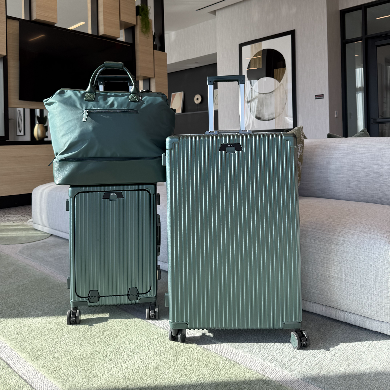 Traveler with a complete matching NOBL luggage set built for years of trips